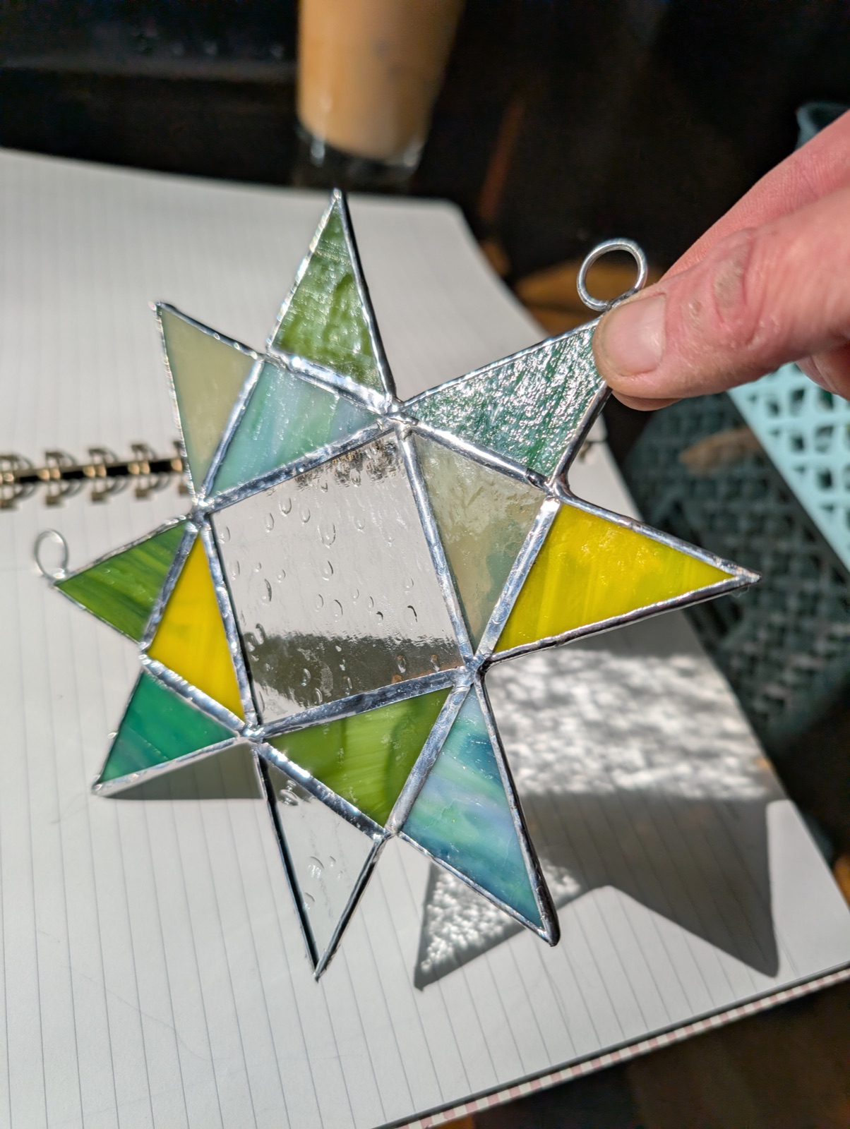 Stained glass star in green, yellow, and clear glass
