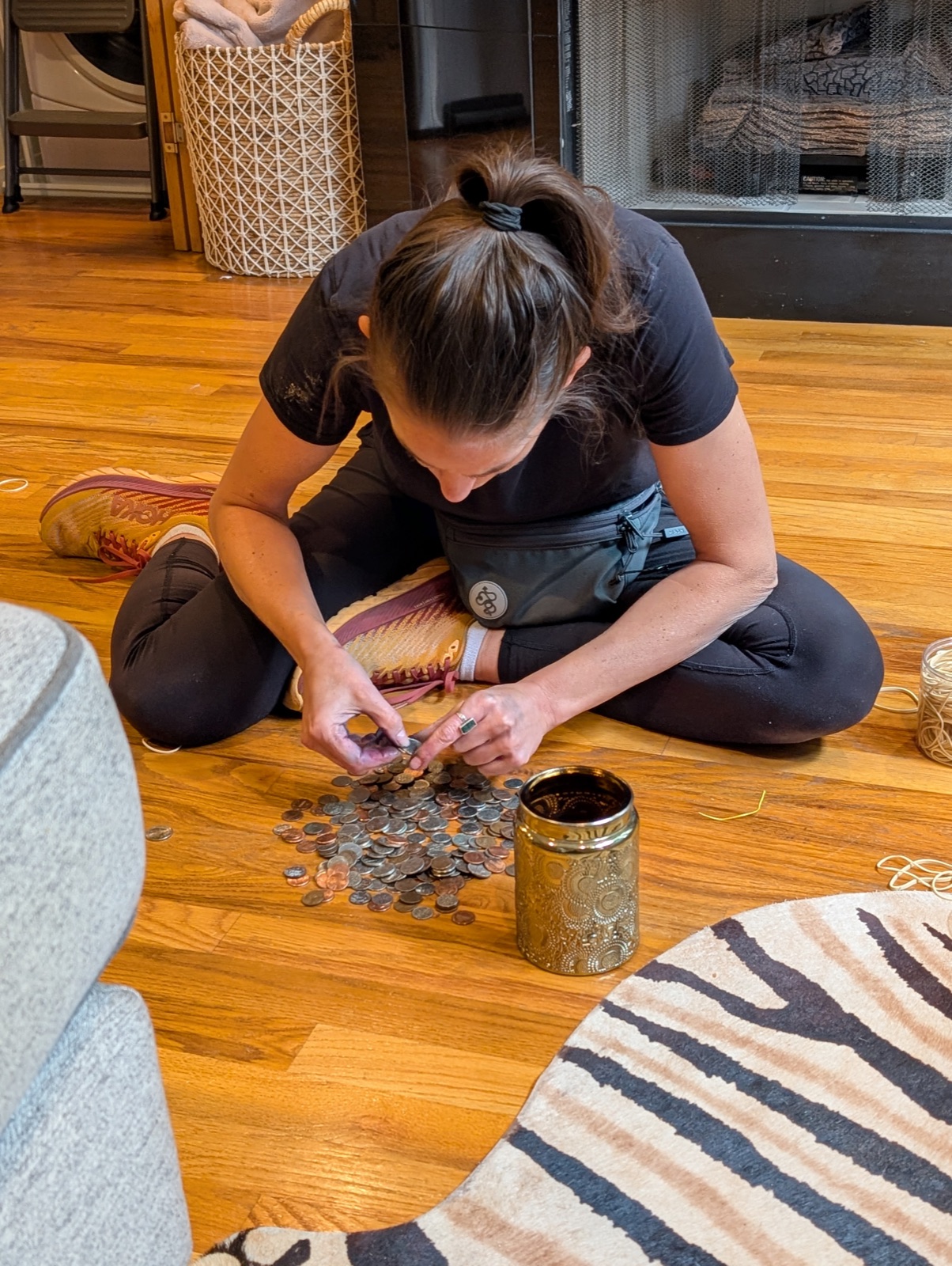 Jess sorting coins on the floor