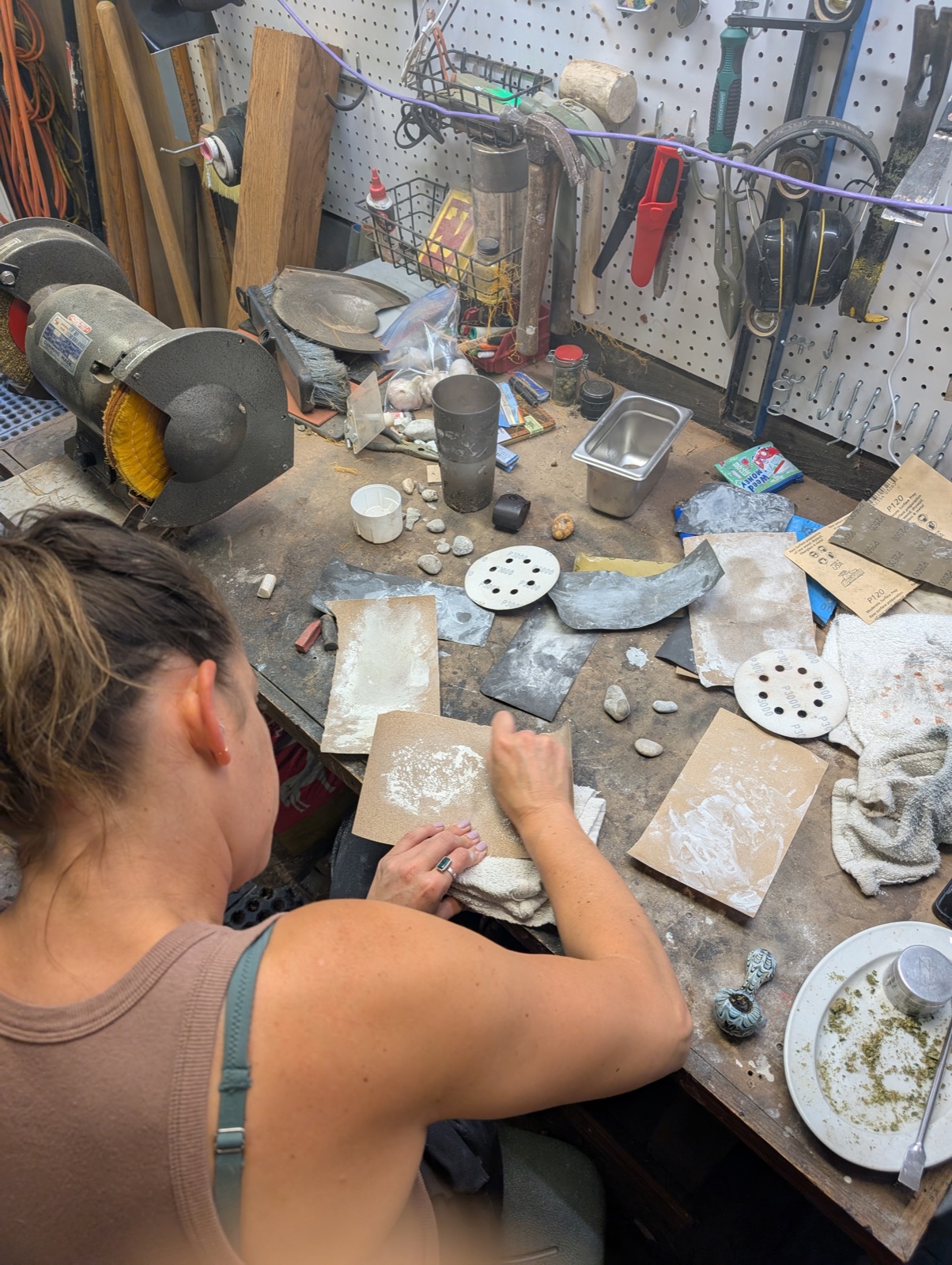 Jess at the bench, sanding stones
